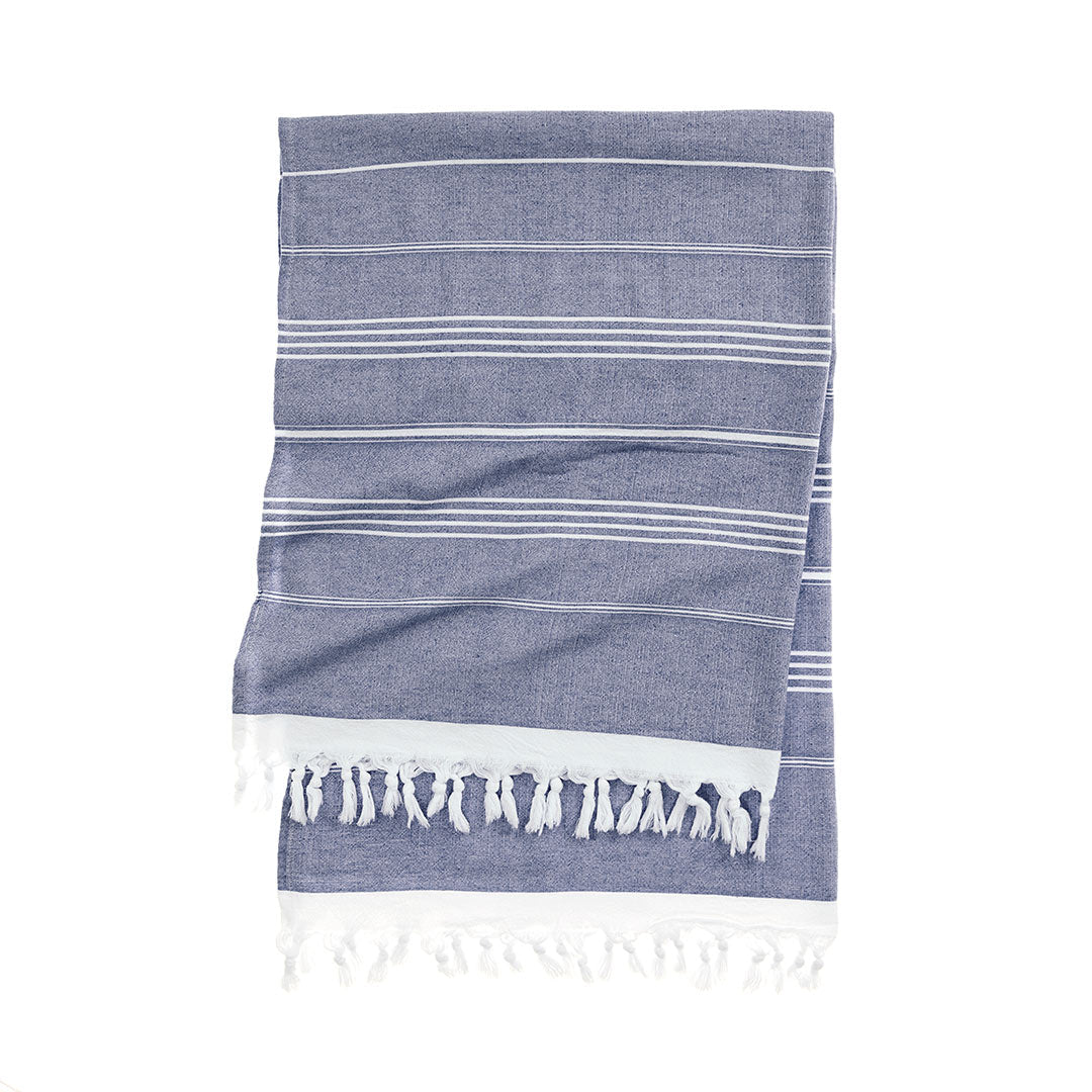 Classic striped towel folded neatly on a sunbed near the ocean