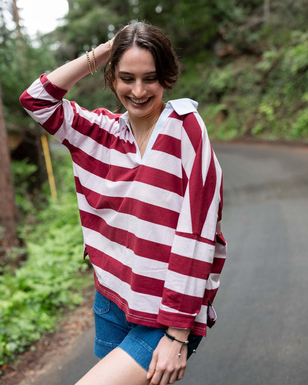 Woman in a red and white striped rugby top and denim shorts