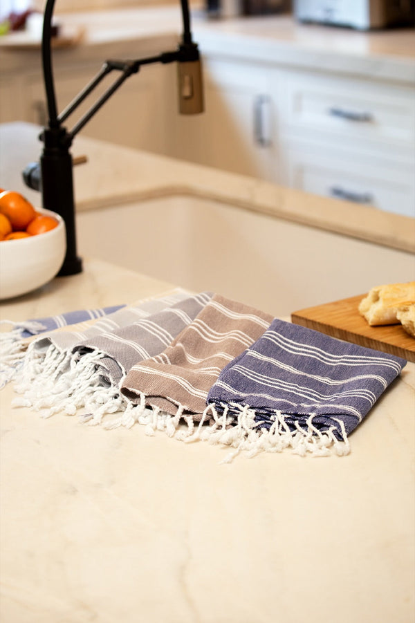 Striped Turkish hand towel on a kitchen counter with fresh bread