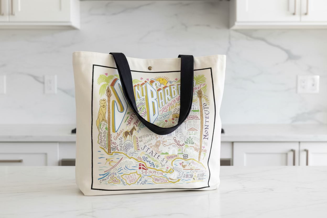 Tote bag with colorful illustration of Santa Barbara on a wooden surface