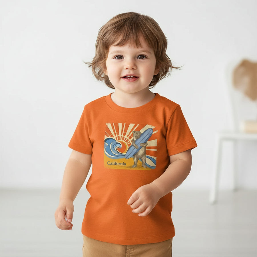 Orange t-shirt with a bear holding a surfboard and 'California' text on a white background