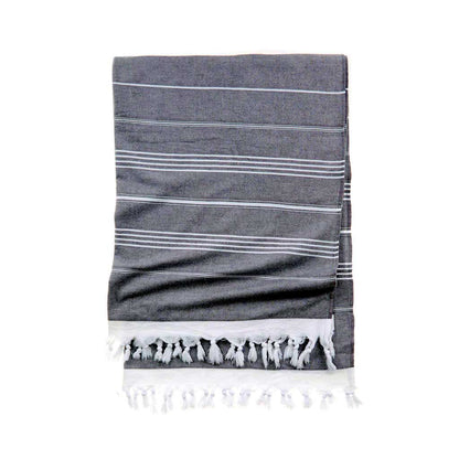 Luxury Turkish cotton beach towel folded on lounge chair