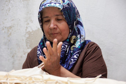 Turkish artisan finishing towel fringe by hand
