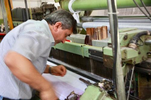 Technician adjusting a loom at the mill