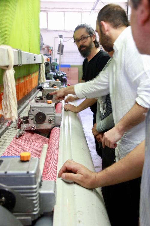 Inspecting fabric as it comes off the loom