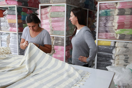 Checking a striped towel at the factory