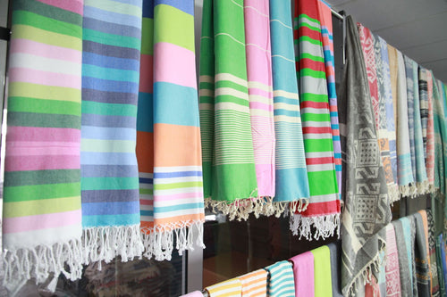 Bright striped Turkish towels hanging in the factory showroom